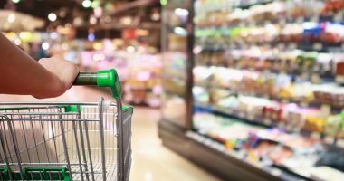 Woman pushing a supermarket trolley