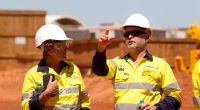 Two Grueye joint venture workers talk at the front of the gold mine.