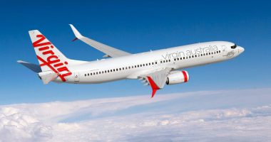 A Virgin Australia plane flies through the clouds.